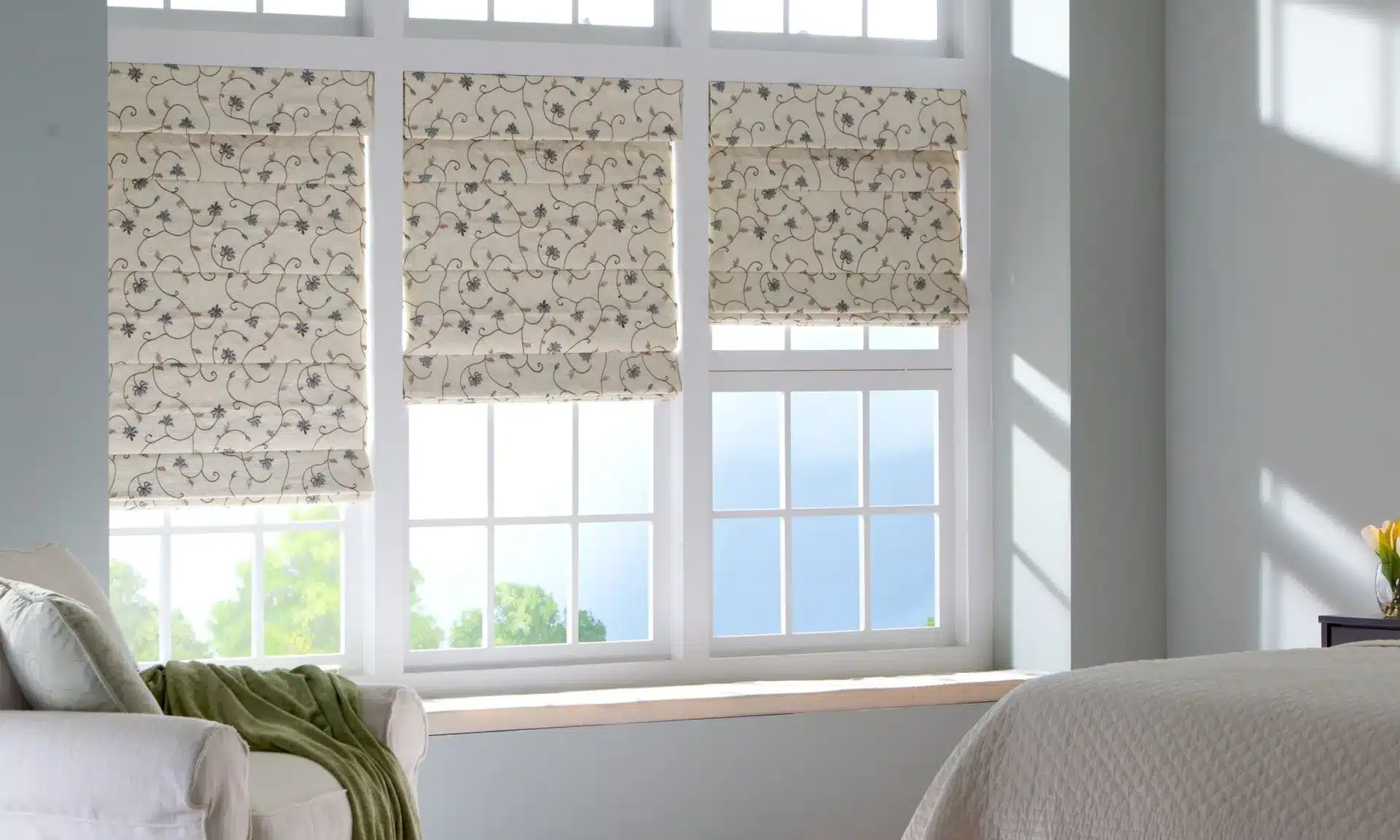 Fabric roman shades in a bedroom